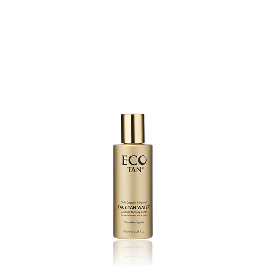 A gold cylindrical bottle of Face Tan Water by Eco Tan features a metallic cap and a label that reads "Natural Organic Face Tan Water & Gradual Tanning Toner," offering a healthy golden glow. Set against a white background, this skincare essential elevates your routine to an elite level.