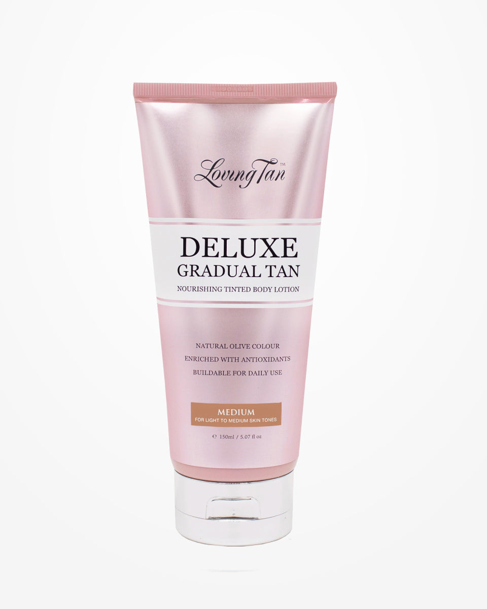 A pink tube of Loving Tan's Deluxe Gradual Tan, complete with a silver cap, offers a lightweight body lotion enriched with antioxidants. It's ideal for medium skin tones and can be built up daily to achieve a natural olive color that competes with any mousse tan.