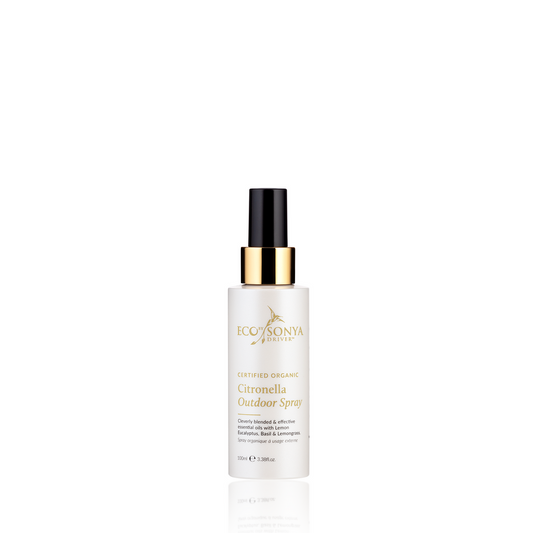 A bottle of Eco Tan Citronella Personal Outdoor Spray. The container is white with a black and gold spray nozzle, featuring text that highlights its certified organic ingredients, including refreshing eucalyptus.