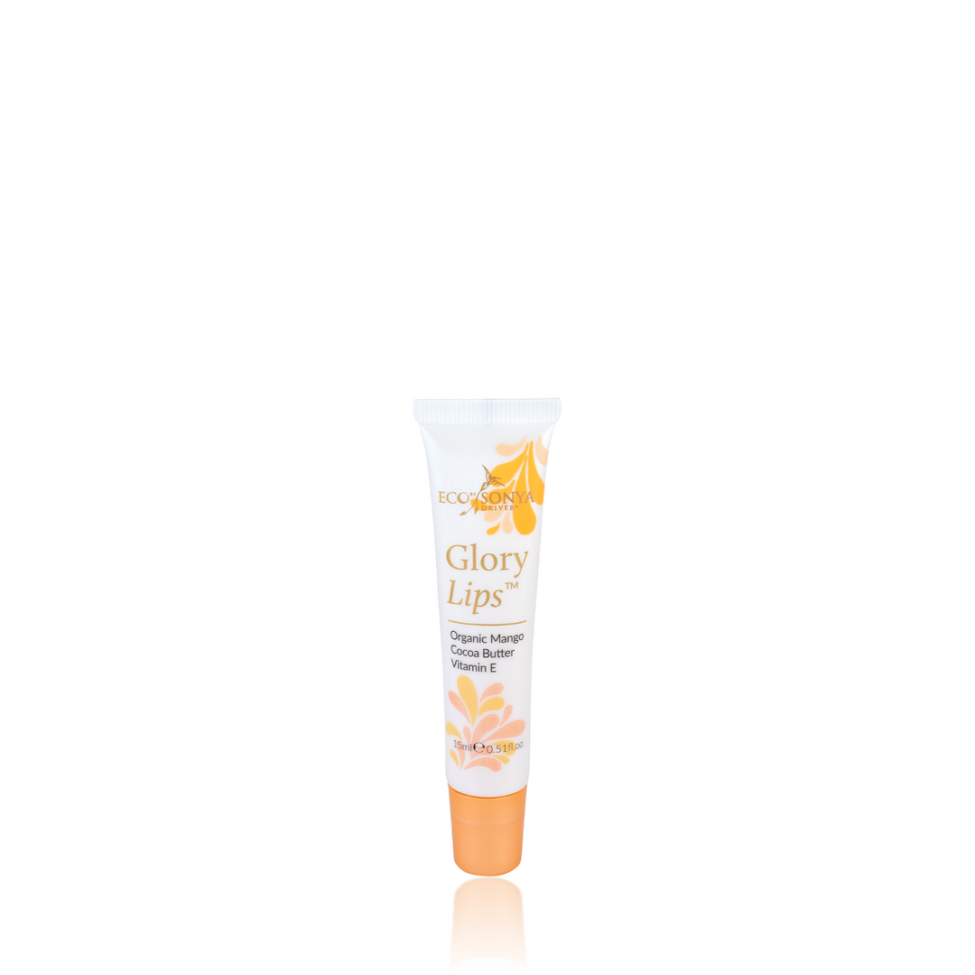 A tube of Eco Tan lip balm called "Glory Lips" contains organic mango, shea butter, and vitamin E. The white tube is adorned with vibrant orange and yellow floral designs.