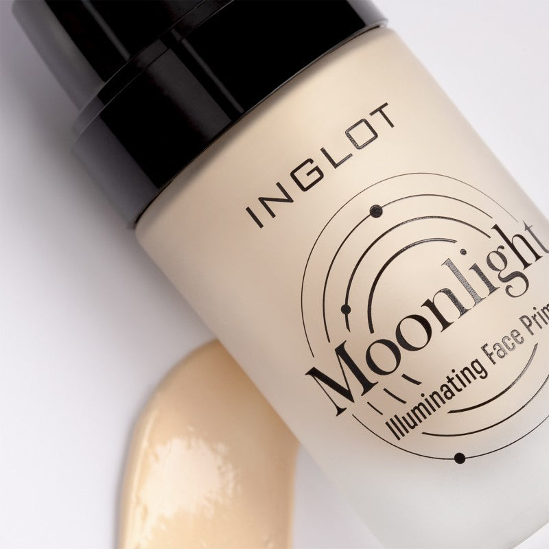 A close-up of the Inglot Moonlight Illuminating Face Primer resting on a white surface, ideal for makeup preparation. The product features a black cap and minimalist design, adorned with a scientific graphic around the text. It is accompanied by a translucent beige smear that offers a natural glow.